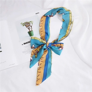 Detail of silk scarf tied in a bow featuring vintage horse and buckle print patterns