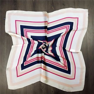 Navy and magenta geometric square silk scarf with satin finish on wooden floor