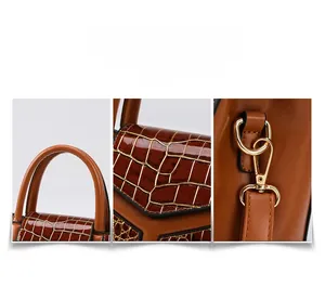 Détails de la texture crocodile marron et des finitions en métal doré sur le sac à main