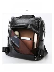 Detailed interior of black leather backpack showing capacity for iPad and umbrella