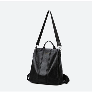 Detail of black leather backpack featuring gold lettering and removable shoulder strap