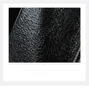 Close-up of premium black pebble grain leather texture with elegant soft glossy finish