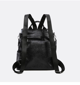 Rear view of black leather backpack showing adjustable straps and anti-theft zipper pocket