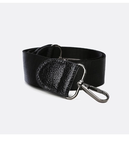 Detail of black nylon strap with lychee grain leather and gunmetal swivel hook buckle