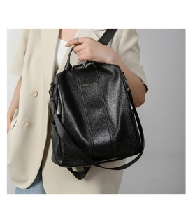 Detail view of high-quality black faux leather backpack with adjustable shoulder straps