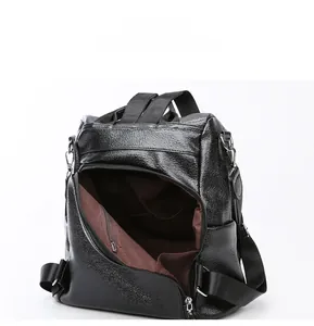 Detail view of anti-theft backpack interior with zip pocket and brown fabric lining