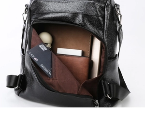 Interior view of black faux leather backpack showing card slots and spacious compartments