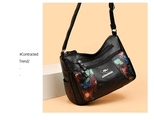 Detail of soft black leather bag featuring retro floral prints and metal kangaroo logo