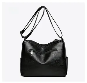 Detail view of the black PU leather crossbody bag back with functional zipper pocket