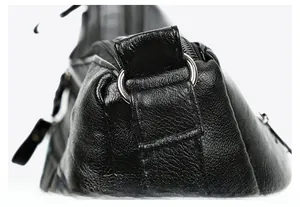 Macro detail of lychee texture black leather bag with metal reinforcement rings