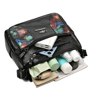 Three-layer floral printed leather crossbody bag showing large storage capacity