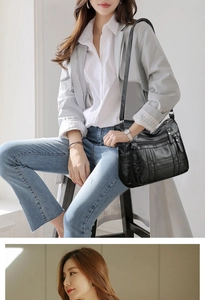 Detail der schwarzen Kunstledertasche mit gewebter Textur und mehreren Reißverschlusstaschen