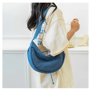 Close-up of lightweight blue nylon crescent bag with adjustable wide fabric strap