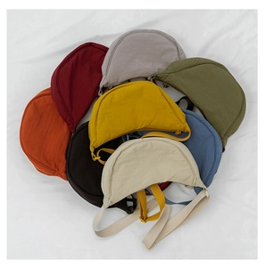 Selection of colorful nylon crescent crossbody bags with adjustable straps in various shades