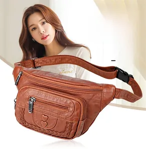 Macro detail of brown soft leather waist bag with heart relief and woven border