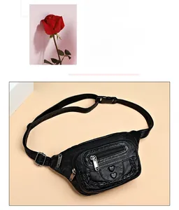 Detail of soft black PU leather waist bag with heart charms and woven texture