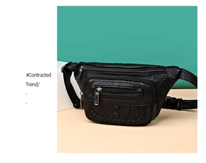 Detail of black faux leather waist bag showing three zip pockets and heart embossed pattern