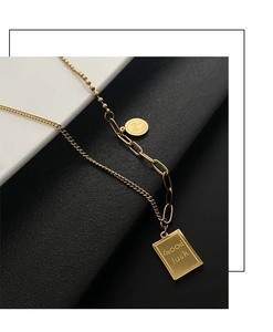 Detailed macro view of gold-plated titanium steel necklace with Good Luck pendants