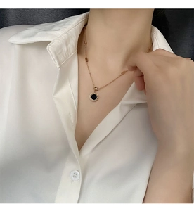 Détail du collier en or rose avec chiffres romains et pendentif en onyx noir