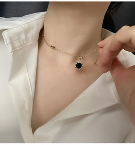 Détail du collier en or rose avec pendentif chiffres romains porté sur chemise