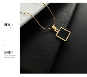 Detailed view of a gold-tone beaded necklace featuring a minimalist square black pendant