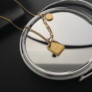 Minimalist gold titanium necklace with square book pendant and good luck smiley charm