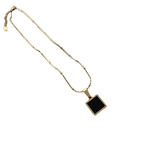 Minimalist gold titanium steel necklace featuring a geometric square black enamel pendant