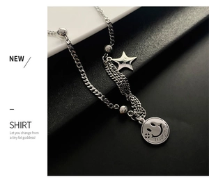 Detailed close-up of a silver stainless steel chain necklace with lucky star and smiley face charms