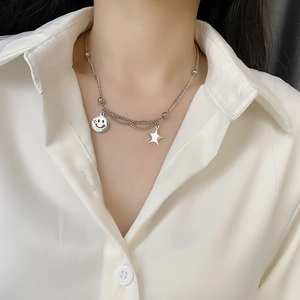 Silver smile pendant necklace with star detail on layered chain for women