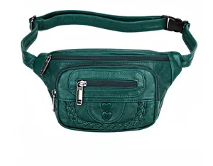Detail view of dark green faux leather waist bag with heart embossing and triple zippers