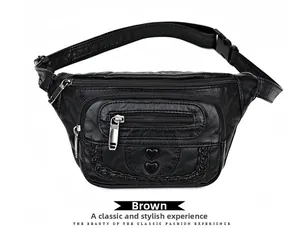 Detail of soft leather waist bag showing black heart accents and woven edge trim