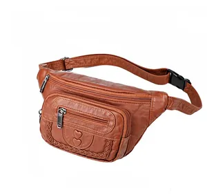 Detail view of brown PU leather waist bag with heart embossing and multi-zipper pockets
