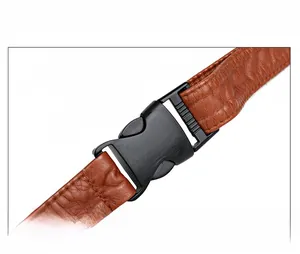 Detail of durable PVC buckle and brown crocodile texture leather strap on waist bag