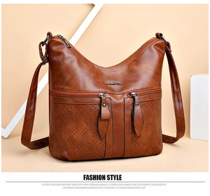 Détail du sac en cuir PU marron avec motifs perforés laser et logo en métal