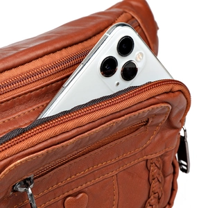 Brown soft leather waist bag with multi-zipper pockets and heart detail showing phone fit