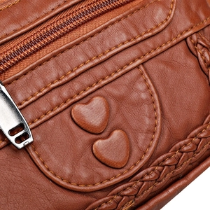 Brown soft leather waist bag with stitched heart detail and woven edge trim