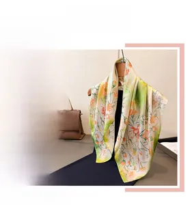 Close-up of floral printed faux silk scarf with elegant drape on wooden hanger