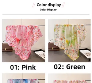 Detail showing floral print silk-like scarves in pink and green on a metal rack