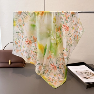 Detail of floral printed faux silk scarf showing lightweight texture and elegant drape