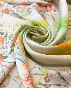 Close-up of floral printed silk scarf showing luxurious twill texture and satin gloss