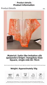 Close-up of orange and white floral satin silk scarf draped over a metal display bar