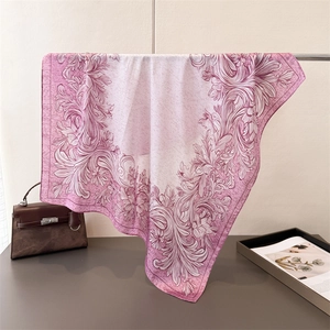 Detailed view of floral silk scarf featuring elegant vintage botanical prints in soft pink