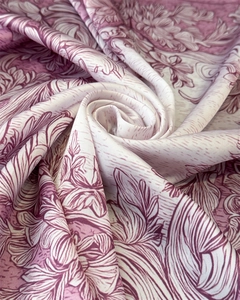 Detailed view of floral silk scarf featuring elegant rose patterns and smooth satin texture