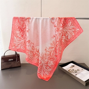 Close-up of coral and white silk square scarf with vintage baroque floral patterns