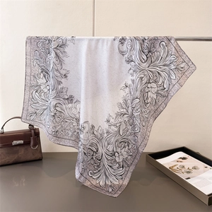 Detailed drape of floral silk scarf showing baroque pattern in grey and purple tones
