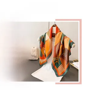 Detail of geometric pattern silk scarf with elegant orange and green color blocking