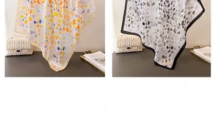 Detailansicht von Seidenquadrattüchern mit Herzmustern in Beige und Schwarz