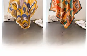 Detailed comparison of two geometric silk scarves in yellow and deep emerald green colors