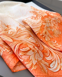 Detailed macro view of the silky floral scarf showing smooth texture and drapes