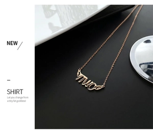 Detail of rose gold pendant necklace featuring artistic cursive Miao letter design